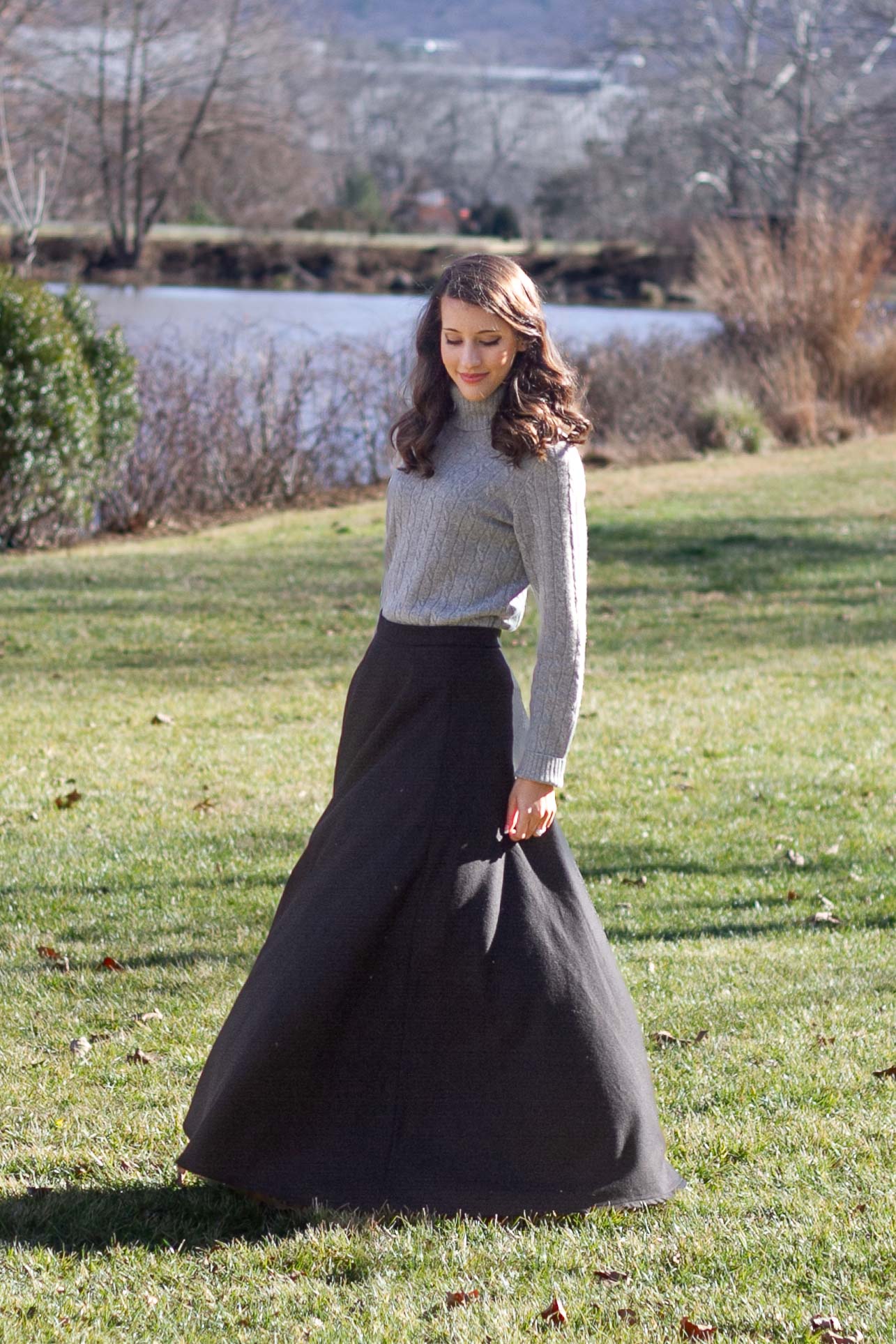 woman in black wool maxi skirt flowing in the wind